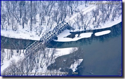 Aerial photo of a snowy train tressel bridge over a river in Pennsylvania