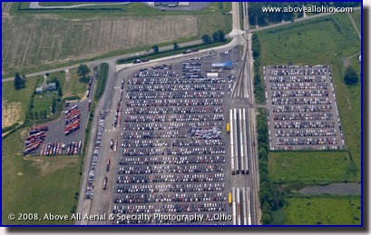 Aerial photo of new cars waiting to be loaded on trucks and rail cars
