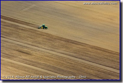 An aerial view of a farmer preparing a field for planting; near Greenwich, Ohio.