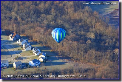 A colorful hot air ballon floats over Ohio in very early spring