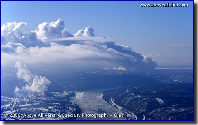 Aerial photograph of an icy Ohio River and power plant steam