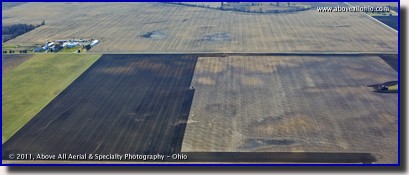 A panoramic aerial view of a farmer perparing a field for spring planting in rural Ohio